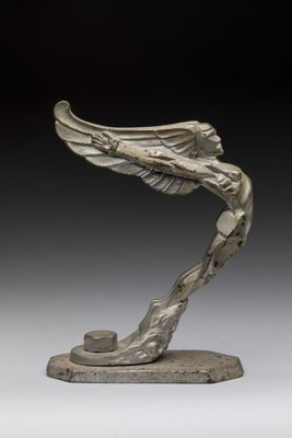 an image of a sculpture of a bird with wings on a base