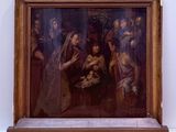 a painting on the wall of a museum with people around it