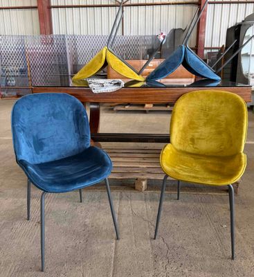 two chairs sitting next to each other in a warehouse