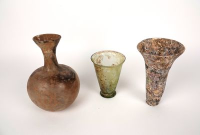 three vases sitting next to each other on a white surface
