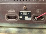 an image of a close up of a metal device with a red wire