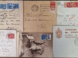 several old postcards and envelopes on a table with stamps on them