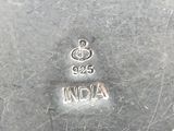 silver plate with the name of india engraved on it