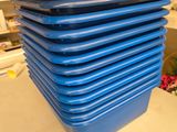 une pile de plateaux bleus posée sur une table