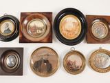 many framed pictures of men and women on the wall