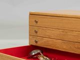 a wooden box with a pair of scissors inside of it
