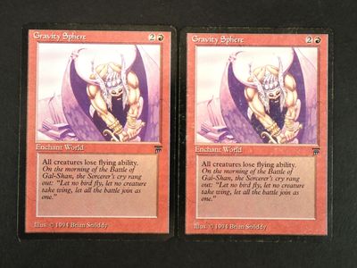 two cards of a card game with a picture of a demon on one of them