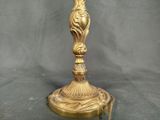 a gold plate with a bird on it on a table