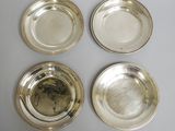 four silver plated dishes on a table with a white background