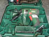 a green case with tools in it sitting on a counter