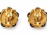a pair of gold and black enamel earrings