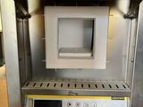 an image of a toaster oven on a wooden table
