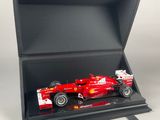 a red ferrari car in a black box on a white background