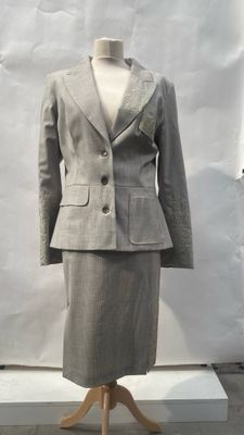 an image of a woman ' s dress and jacket on a mannequin