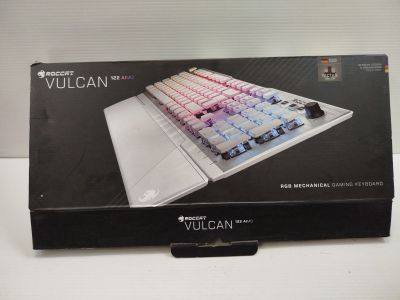 packaging of a white and red keyboard in a box on a table