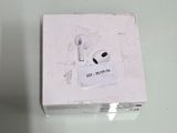 a white box with an earphone in it on a table