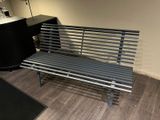a metal bench in the corner of a room
