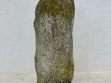 an old stone statue of a man with a hat on his head