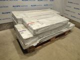 a pile of mattresses sitting on a pallet in a room