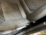 a close up of a car seat with a remote control