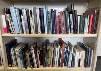 a bookshelf with many books on it in a room