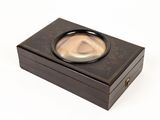 an image of a wooden box with a magnifying glass in it