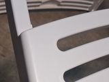 a white plastic chair with a plastic fork on it