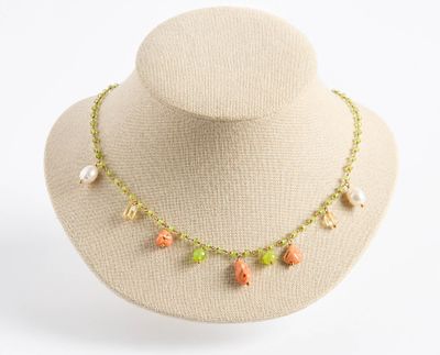 collier composé de perles multicolores et de perles de culture, porté autour du cou d'un mannequin