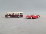 two toy cars sitting next to each other on a table