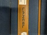 a close up of a blue bag with a tag on it