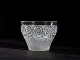 a glass cup that is sitting on a table