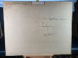 an easel with a piece of paper on it with writing on it