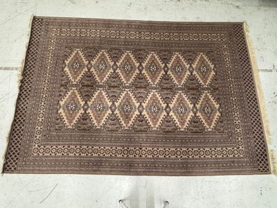 an old rug on the floor with a person standing next to it