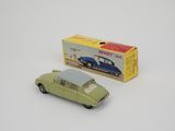 a small toy car sitting next to a boxed box