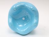 a blue ball with a hole in it on a white surface