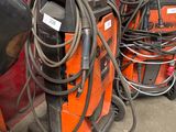 several welding equipment are lined up in a row in a garage
