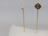 pair of gold plated flower earrings with pearls on a white cloth