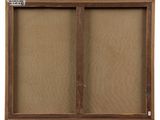 a wooden framed bulletin board with two sliding doors