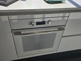 a kitchen with a stove, oven, and sink in it