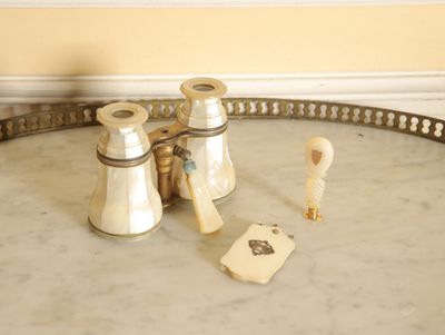a tray that has a pair of binoculars and a card on it