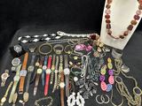 many different types of jewelry displayed on a table