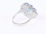 an oval blue topaze and white topaze ring with diamonds
