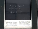a picture of a sign on the side of a building with writing on it