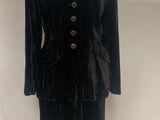 black velvet jacket and skirt suit on a mannequin stand
