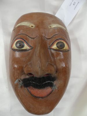 un masque marron orné d'une moustache et d'une barbichette