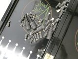 a black piano that has a bunch of black beads on it