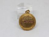 an image of a gold locke with a pink stone in the center