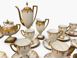 a lot of cups and saucers that are sitting on a table