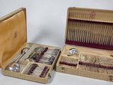 a wooden case with silverware in it on a white surface