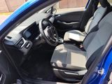 the interior of a blue car with the front seats folded down